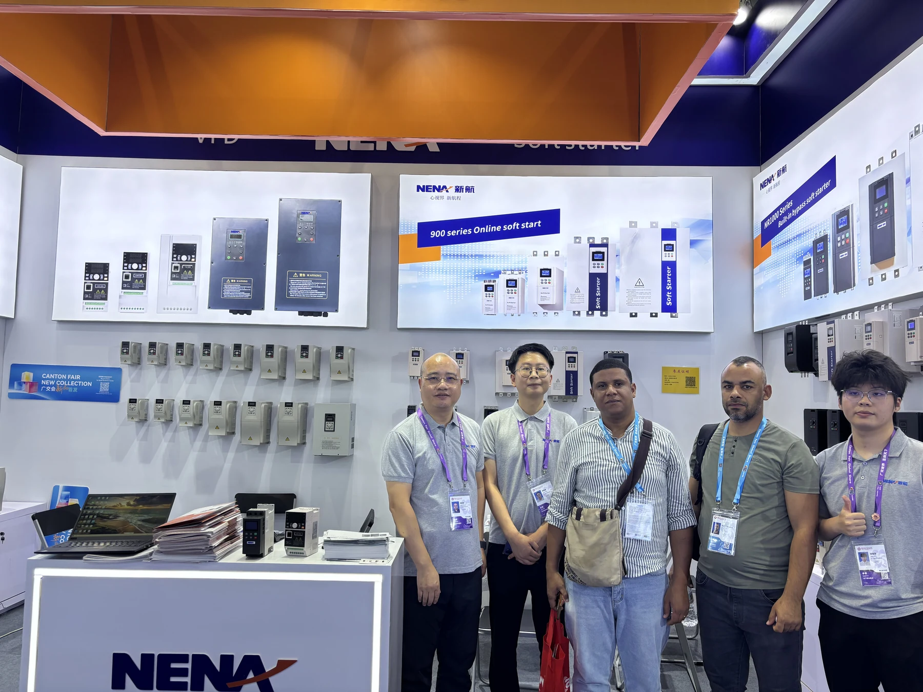 NENA team members and visitors posing beside the soft starter and VFD display at Canton Fair 2026